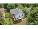 Aerial view of the house with a deck, hot tub, and screened porch surrounded by lush greenery at 3801 Rosedown Dr, Matthews, NC 28105