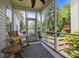 Serene screened porch features comfortable seating and a tranquil view of the landscaped backyard at 3801 Rosedown Dr, Matthews, NC 28105