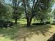 Large, grassy backyard with mature trees at 408 N Hill St, Dallas, NC 28034