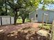 View of the home's backyard with paver patio and exterior storage building at 408 N Hill St, Dallas, NC 28034