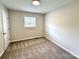 Bedroom featuring neutral carpet, one window, and a white door at 408 N Hill St, Dallas, NC 28034