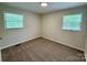 Bedroom with neutral carpet and natural light from two windows at 408 N Hill St, Dallas, NC 28034