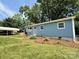 Lovely blue home featuring a well-kept lawn and a charming carport for convenient parking and style at 408 N Hill St, Dallas, NC 28034
