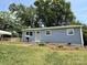 Charming one story home with blue siding, green lawn, and mature trees at 408 N Hill St, Dallas, NC 28034