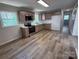 Well-lit kitchen with modern appliances, light wood flooring and ample counter space at 408 N Hill St, Dallas, NC 28034