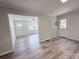 Open floor plan with wood-look flooring, light walls and white trim at 408 N Hill St, Dallas, NC 28034