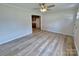 Bright living room with wood-look flooring, neutral walls, and ceiling fan at 408 N Hill St, Dallas, NC 28034