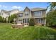 Backyard of home showing a fire pit, patio, and lush lawn at 4117 Bright Rd, Charlotte, NC 28214
