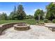 Backyard with a stone fire pit, patio, and a view of the trees and sky at 4117 Bright Rd, Charlotte, NC 28214