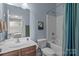 Clean bathroom with a vanity, toilet, and tiled shower-tub combination at 4117 Bright Rd, Charlotte, NC 28214