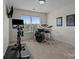 Bedroom with exercise bike, drum set, artwork, and view of trees at 4117 Bright Rd, Charlotte, NC 28214