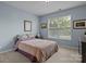 Serene bedroom with light blue walls, plush carpeting, and ample natural light at 4117 Bright Rd, Charlotte, NC 28214
