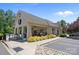 Community clubhouse with covered outdoor seating, mature landscaping, and ample parking on a sunny day at 4117 Bright Rd, Charlotte, NC 28214
