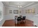 Formal dining room featuring hardwood floors, tray ceiling, and elegant wainscoting at 4117 Bright Rd, Charlotte, NC 28214