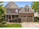 Inviting two-story brick home featuring a two-car garage and a covered front porch at 4117 Bright Rd, Charlotte, NC 28214
