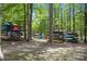 Assorted kayaks stored on wooden racks nestled in the beautiful, verdant woods at 4117 Bright Rd, Charlotte, NC 28214