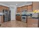 Modern kitchen with stainless steel appliances, granite countertops, and backsplash at 4117 Bright Rd, Charlotte, NC 28214