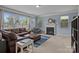Spacious living room with a fireplace, plush seating, a large window, and neutral colored carpet at 4117 Bright Rd, Charlotte, NC 28214