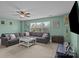 Inviting living room with a large sectional sofa, ceiling fan, and a window with a peaceful view at 4117 Bright Rd, Charlotte, NC 28214