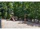 Community playground featuring multiple slides, swings, and climbing structures, surrounded by mature trees at 4117 Bright Rd, Charlotte, NC 28214