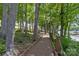 Scenic wooden walking trail winding through mature trees alongside the water, perfect for a leisurely stroll at 4117 Bright Rd, Charlotte, NC 28214
