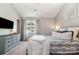 Bedroom features a bed with patterned bedding, a dresser, and a window providing natural light at 4124 Melrose Club Dr, Matthews, NC 28105