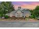 Elegant clubhouse exterior with manicured landscaping and a welcoming entrance, perfect for community gatherings at 4124 Melrose Club Dr, Matthews, NC 28105
