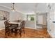 Open-concept dining area with hardwood floors, traditional furnishings, and plenty of natural light at 4124 Melrose Club Dr, Matthews, NC 28105