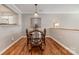 Charming dining area featuring beautiful hardwood floors, and a view into kitchen at 4124 Melrose Club Dr, Matthews, NC 28105