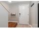 Clean, modern entryway with a white door, tile flooring, and a convenient coat rack at 4124 Melrose Club Dr, Matthews, NC 28105