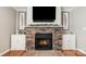 Elegant fireplace with a stone surround, built-in cabinets, and decorative accents at 4124 Melrose Club Dr, Matthews, NC 28105