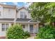 Charming townhouse featuring a well-maintained yard with mature landscaping and a welcoming front porch at 4124 Melrose Club Dr, Matthews, NC 28105