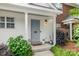 Close-up of a cozy front porch with stylish planters, a welcome mat, and a charming exterior light fixture at 4124 Melrose Club Dr, Matthews, NC 28105