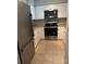 Well-lit kitchen featuring white cabinets, stainless steel appliances, and tile flooring at 4124 Melrose Club Dr, Matthews, NC 28105