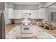 Bright kitchen with white cabinets, neutral countertops, and modern appliances at 4124 Melrose Club Dr, Matthews, NC 28105