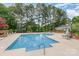 Large community swimming pool with plenty of lounge chairs and beautiful green trees surrounding the area at 4124 Melrose Club Dr, Matthews, NC 28105