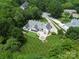Aerial view showcasing home with a putting green, patio and a manicured lawn at 4201 Quail Hunt Ln, Charlotte, NC 28226