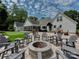 Outdoor patio with comfortable seating around a stone fire pit at 4201 Quail Hunt Ln, Charlotte, NC 28226