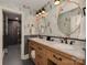 The bathroom boasts whimsical monkey wallpaper, double sinks, and a walk-in shower with a black tile surround at 4201 Quail Hunt Ln, Charlotte, NC 28226