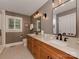 Bright bathroom featuring double sinks, modern fixtures, a walk-in shower, and decorative mirrors at 4201 Quail Hunt Ln, Charlotte, NC 28226