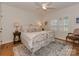 This is a cozy bedroom with an ornate bed frame, wooden floors, light colored walls, and a large window at 4201 Quail Hunt Ln, Charlotte, NC 28226