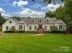 Sprawling single story home featuring well manicured yard, dormer windows, and symmetrical design elements at 4201 Quail Hunt Ln, Charlotte, NC 28226