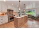 Gourmet kitchen featuring a large island, modern appliances, custom cabinetry, and an eat-in dining space at 4201 Quail Hunt Ln, Charlotte, NC 28226