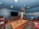 The finished attic features dark blue walls, leather furniture, and plenty of space for a living room at 4201 Quail Hunt Ln, Charlotte, NC 28226