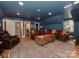 Finished basement with dark blue walls, leather furniture, and a sectional sofa at 4201 Quail Hunt Ln, Charlotte, NC 28226