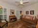 Comfortable living room with hard wood floors, natural light from the windows, and a plush couch at 4201 Quail Hunt Ln, Charlotte, NC 28226