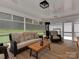 Screened porch with cozy seating, ceiling fan, and views of the backyard at 4201 Quail Hunt Ln, Charlotte, NC 28226