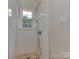 Bathroom shower with a rainfall shower head, white subway tile, and natural light from a small window at 4201 Quail Hunt Ln, Charlotte, NC 28226