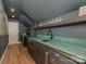 Finished basement with an emerald green countertop, built-in shelves, and a bar sink at 4201 Quail Hunt Ln, Charlotte, NC 28226