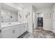 Bathroom featuring double sink vanity, tile flooring, framed mirrors, and a walk-in closet at 449 Misty Law Ln, Clover, SC 29710